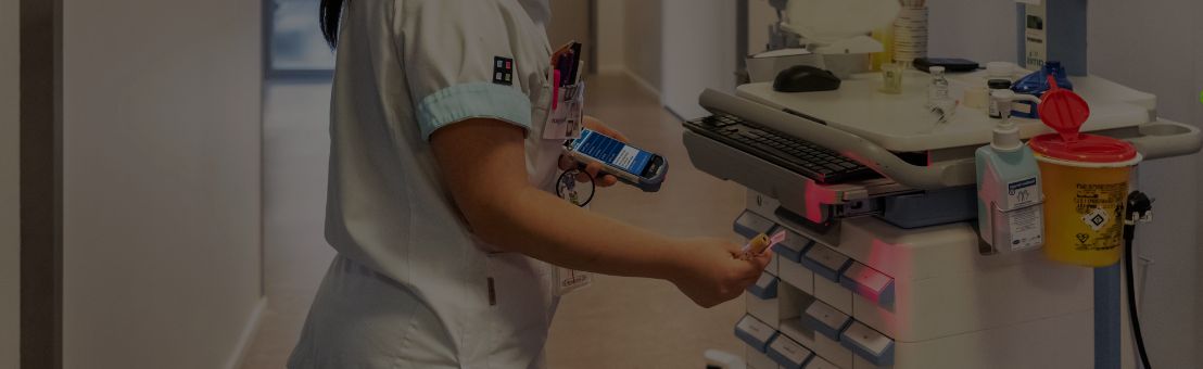 Nurse scanning equipment in hospital hallway